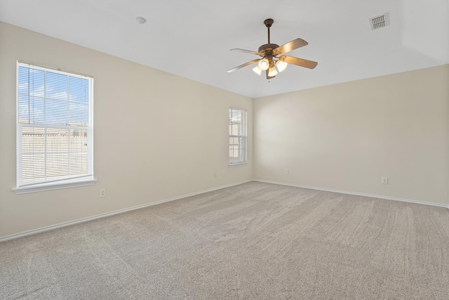 empty room featuring ceiling fan and light carpet