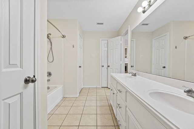 bathroom with tile patterned flooring, vanity, a textured ceiling, and shower / tub combination