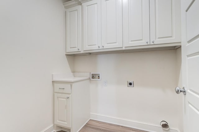 washroom featuring hookup for a washing machine, hookup for an electric dryer, cabinets, and light hardwood / wood-style flooring