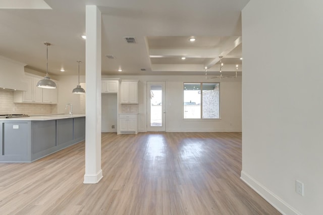 unfurnished living room with sink and light hardwood / wood-style flooring