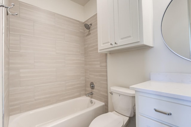 full bathroom featuring tiled shower / bath, vanity, and toilet