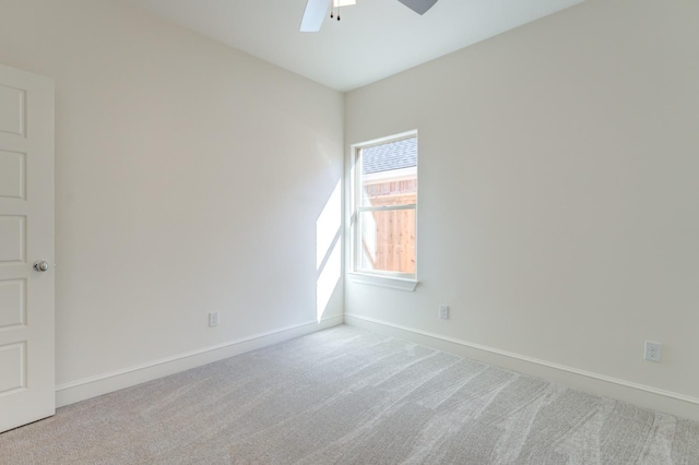 carpeted spare room with ceiling fan