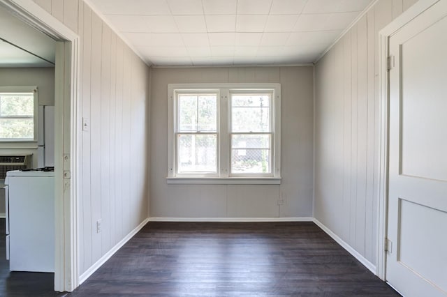 spare room with crown molding and dark wood-type flooring