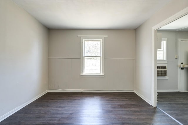 empty room with cooling unit and dark hardwood / wood-style floors