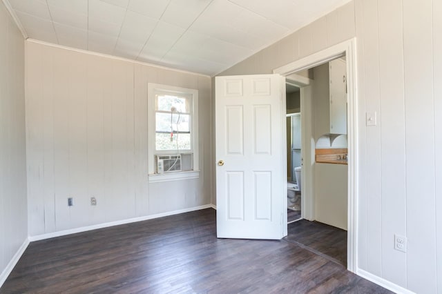 unfurnished bedroom featuring crown molding, dark hardwood / wood-style floors, cooling unit, and wood walls