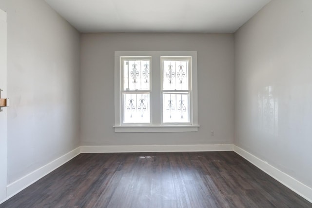 unfurnished room with dark hardwood / wood-style floors