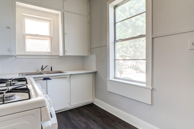 kitchen with white cabinetry, sink, dark wood-type flooring, and white range with gas cooktop