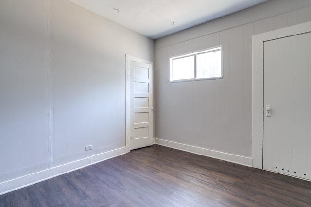 unfurnished room with dark hardwood / wood-style floors