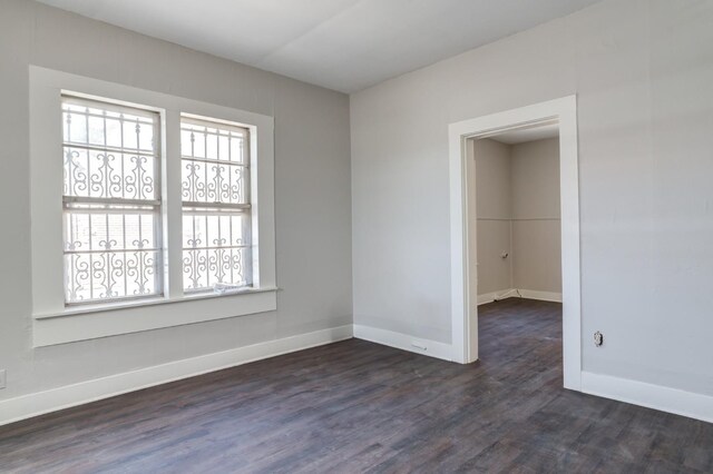 spare room with dark wood-type flooring