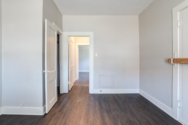 corridor featuring dark hardwood / wood-style floors