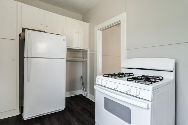 kitchen featuring dark wood-type flooring, white appliances, and white cabinets