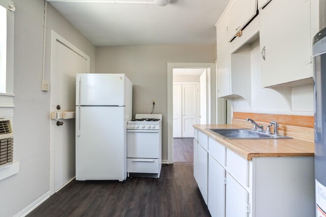 kitchen featuring white appliances, dark hardwood / wood-style flooring, sink, and white cabinets