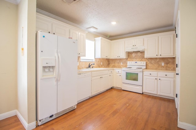 kitchen with backsplash, white cabinets, ornamental molding, light hardwood / wood-style floors, and white appliances