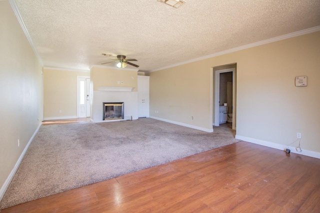 unfurnished living room with hardwood / wood-style flooring, ornamental molding, a textured ceiling, and ceiling fan