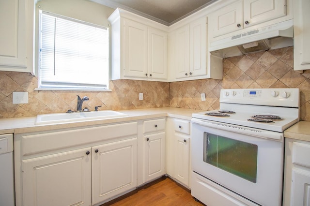 kitchen featuring white appliances, sink, and white cabinets