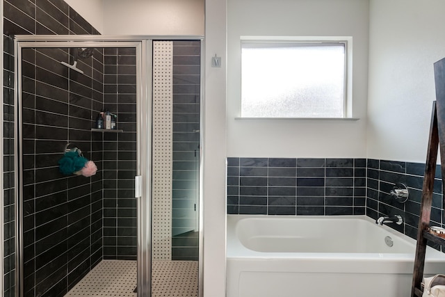 bathroom featuring separate shower and tub