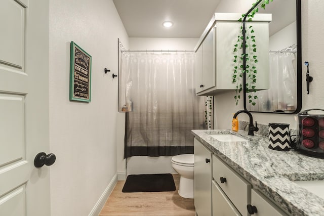 full bathroom featuring vanity, toilet, hardwood / wood-style floors, and shower / bath combo