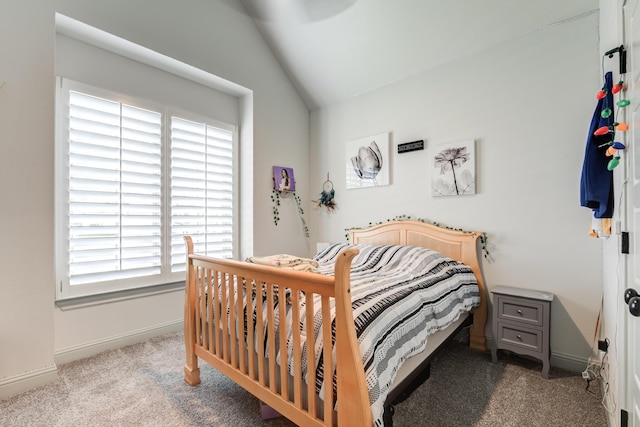 bedroom with lofted ceiling and light carpet