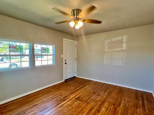 spare room featuring wood-type flooring and ceiling fan