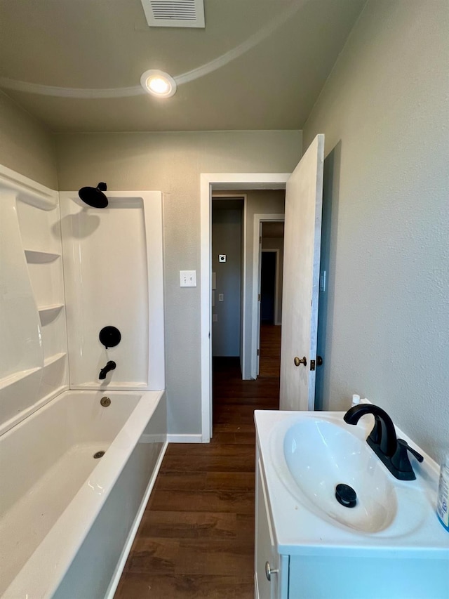 bathroom with vanity, shower / bath combination, and wood-type flooring