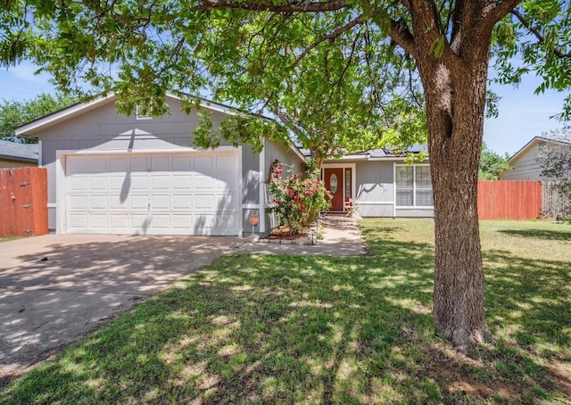 ranch-style home featuring a garage and a front lawn