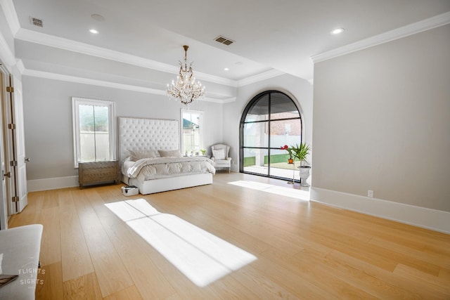 unfurnished bedroom featuring crown molding, an inviting chandelier, light hardwood / wood-style floors, and access to outside