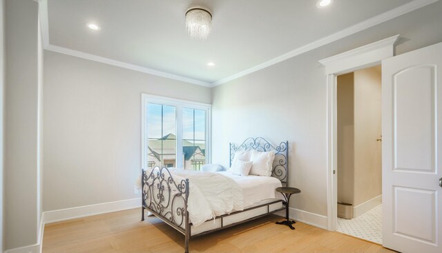 bedroom with crown molding and light hardwood / wood-style flooring