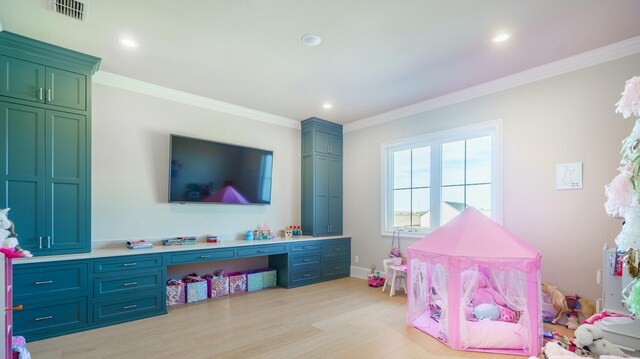 playroom with crown molding and light hardwood / wood-style flooring