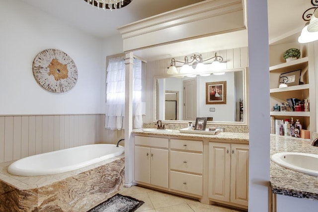 11507 Topeka Ave, Lubbock, TX 79424 - bathroom with double vanity, a garden tub, and tile patterned floors