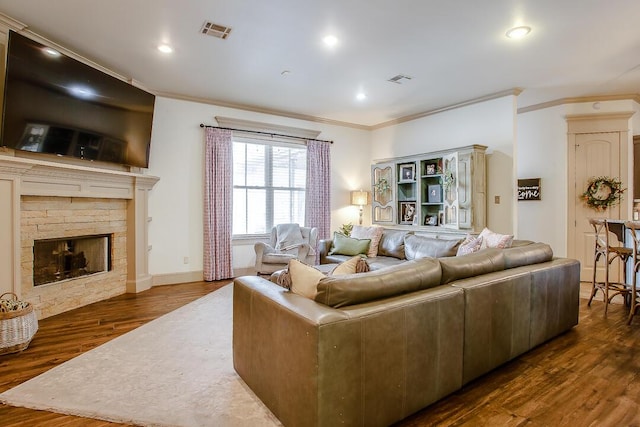 11507 Topeka Ave, Lubbock, TX 79424 - living room featuring ornamental molding, dark wood finished floors, recessed lighting, and a stone fireplace