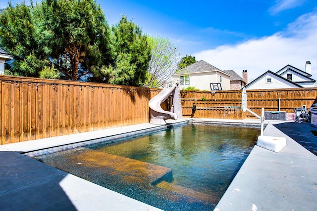 11507 Topeka Ave, Lubbock, TX 79424 - view of swimming pool featuring a water slide and a fenced backyard