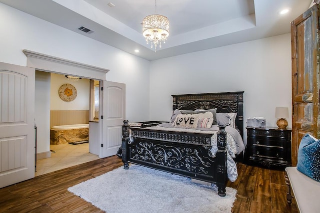 11507 Topeka Ave, Lubbock, TX 79424 - bedroom with a chandelier, wood finished floors, a tray ceiling, ensuite bath, and recessed lighting