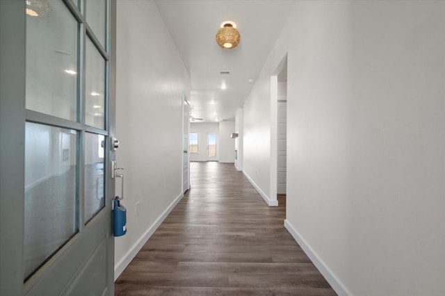 corridor with dark hardwood / wood-style flooring