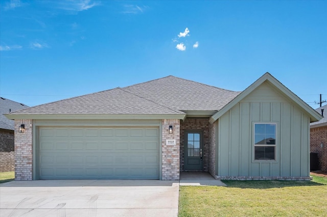 single story home featuring a garage and a front lawn