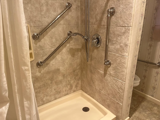 bathroom with tile patterned flooring, curtained shower, and toilet