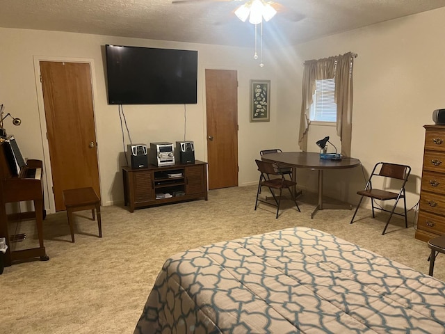 bedroom featuring light carpet and a textured ceiling