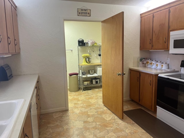 kitchen featuring sink and white appliances