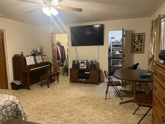 interior space featuring ceiling fan and a textured ceiling