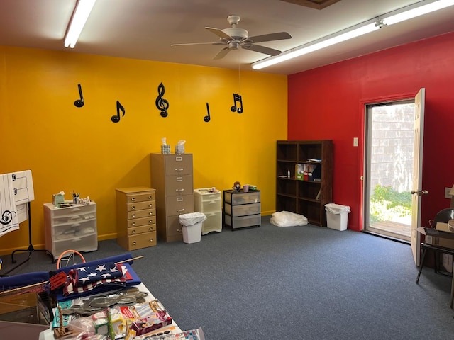 miscellaneous room with dark carpet and ceiling fan