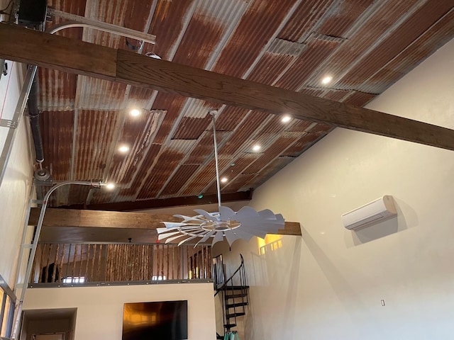 interior details featuring a wall mounted air conditioner and beam ceiling