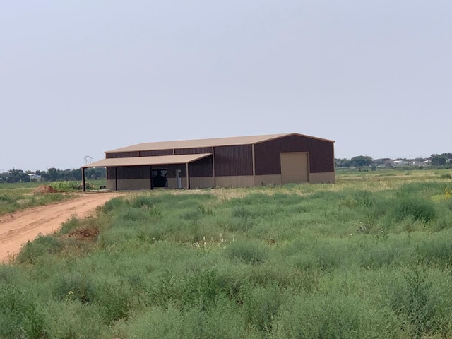 view of horse barn featuring a rural view