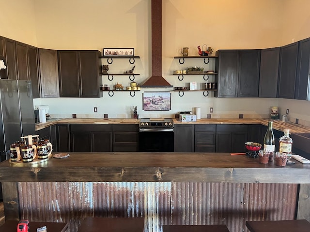 kitchen with dark brown cabinets, stainless steel appliances, and island exhaust hood