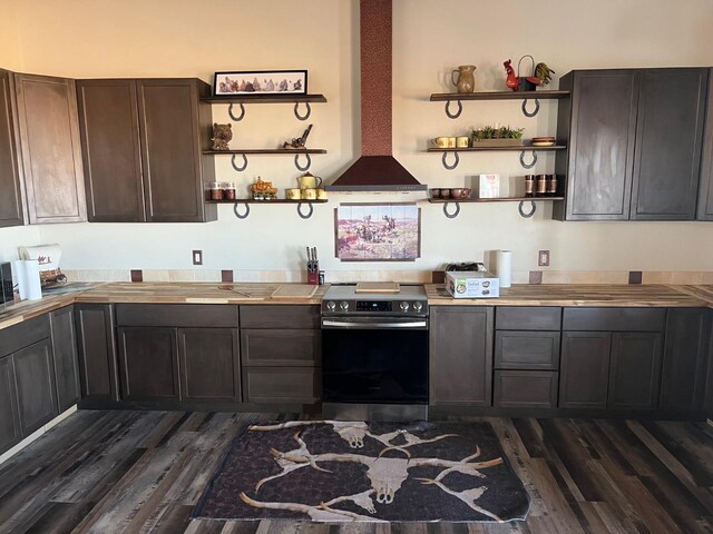 kitchen featuring stainless steel range with electric stovetop, dark hardwood / wood-style flooring, ventilation hood, and dark brown cabinetry