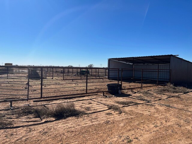 view of yard featuring a rural view and an outdoor structure