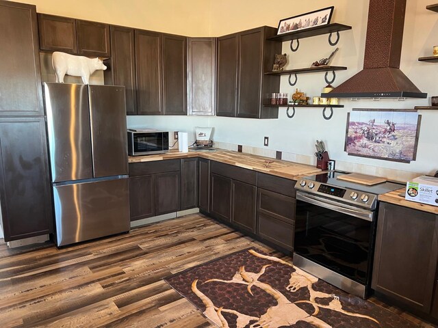 kitchen with stainless steel appliances, island exhaust hood, hardwood / wood-style floors, and dark brown cabinetry