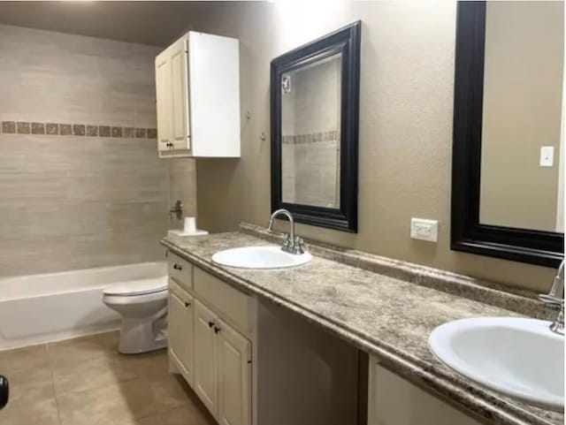 full bathroom with tile patterned floors, vanity, toilet, and tiled shower / bath