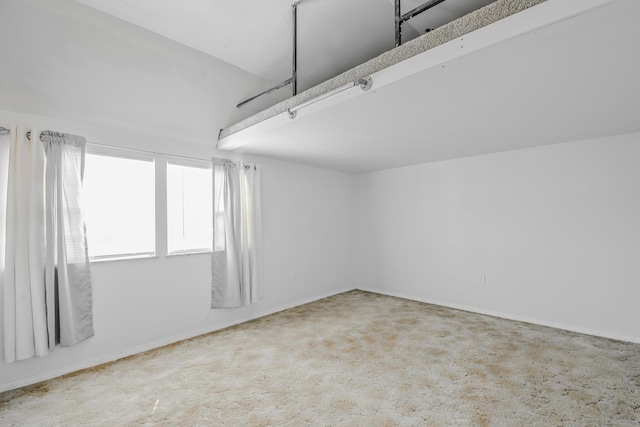 unfurnished room featuring baseboards and carpet floors