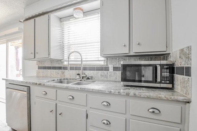 kitchen with light countertops, a sink, and stainless steel appliances
