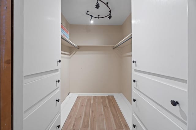 walk in closet featuring light hardwood / wood-style flooring