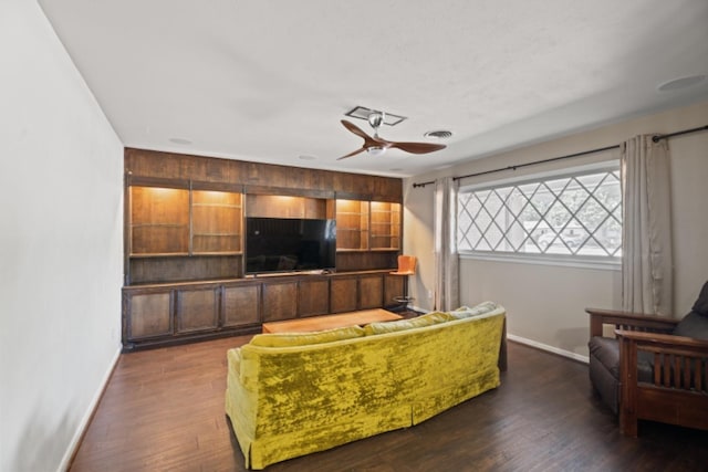 living room with dark wood-type flooring and ceiling fan